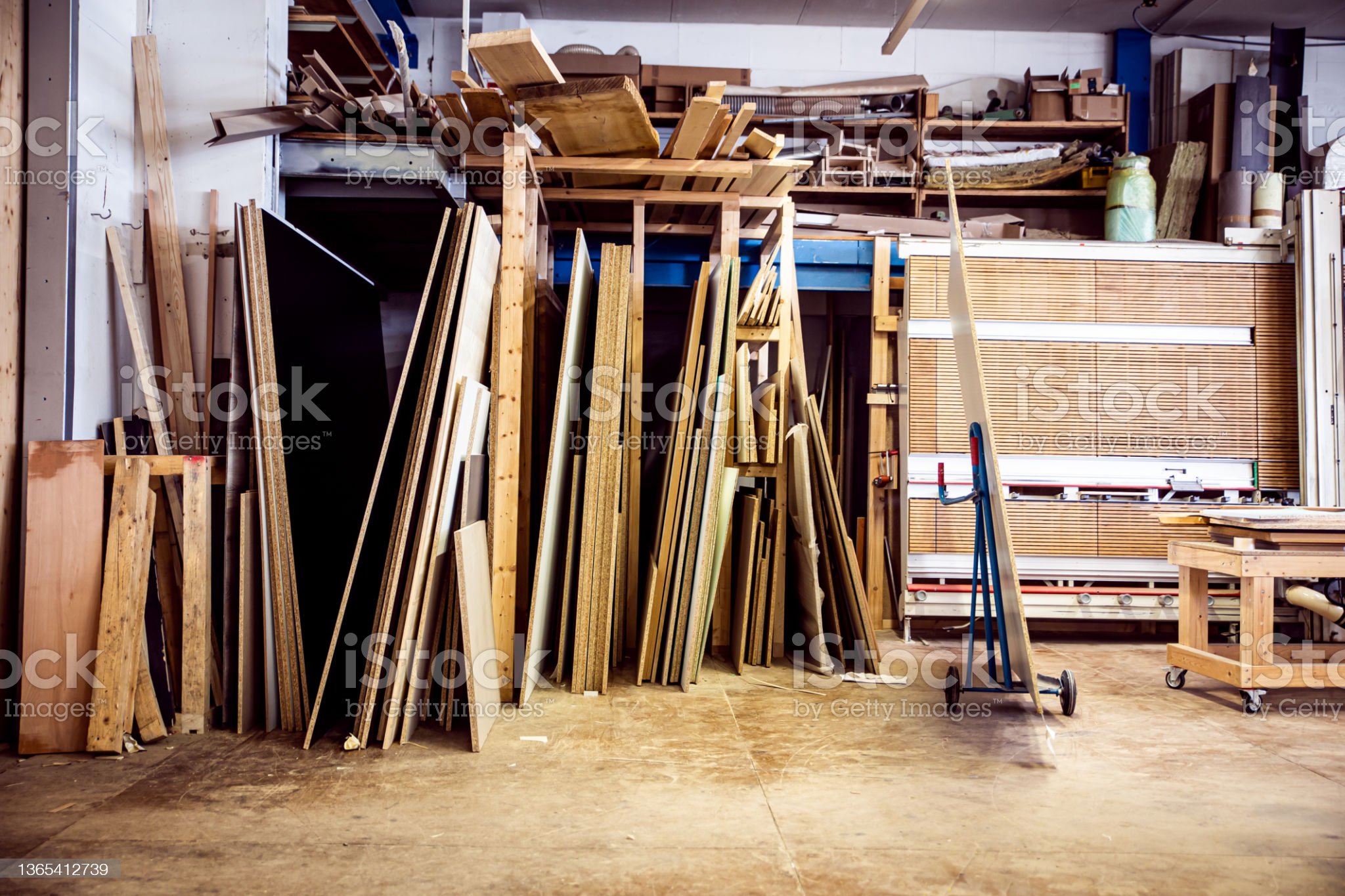 warehouse or workshop in a hardware store, warehouse with wooden boards and a vertical panel saw